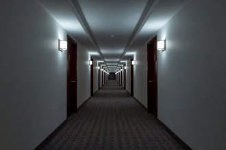 Symmetrical one-point perspective hotel corridor