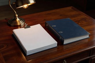 Bound multi-episode shooting screenplay on mahogany desk